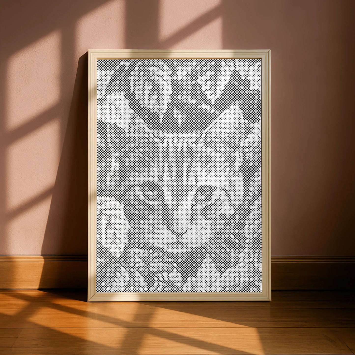 Framed lace art of a cat's face on a pink wall with sunlight casting shadows.