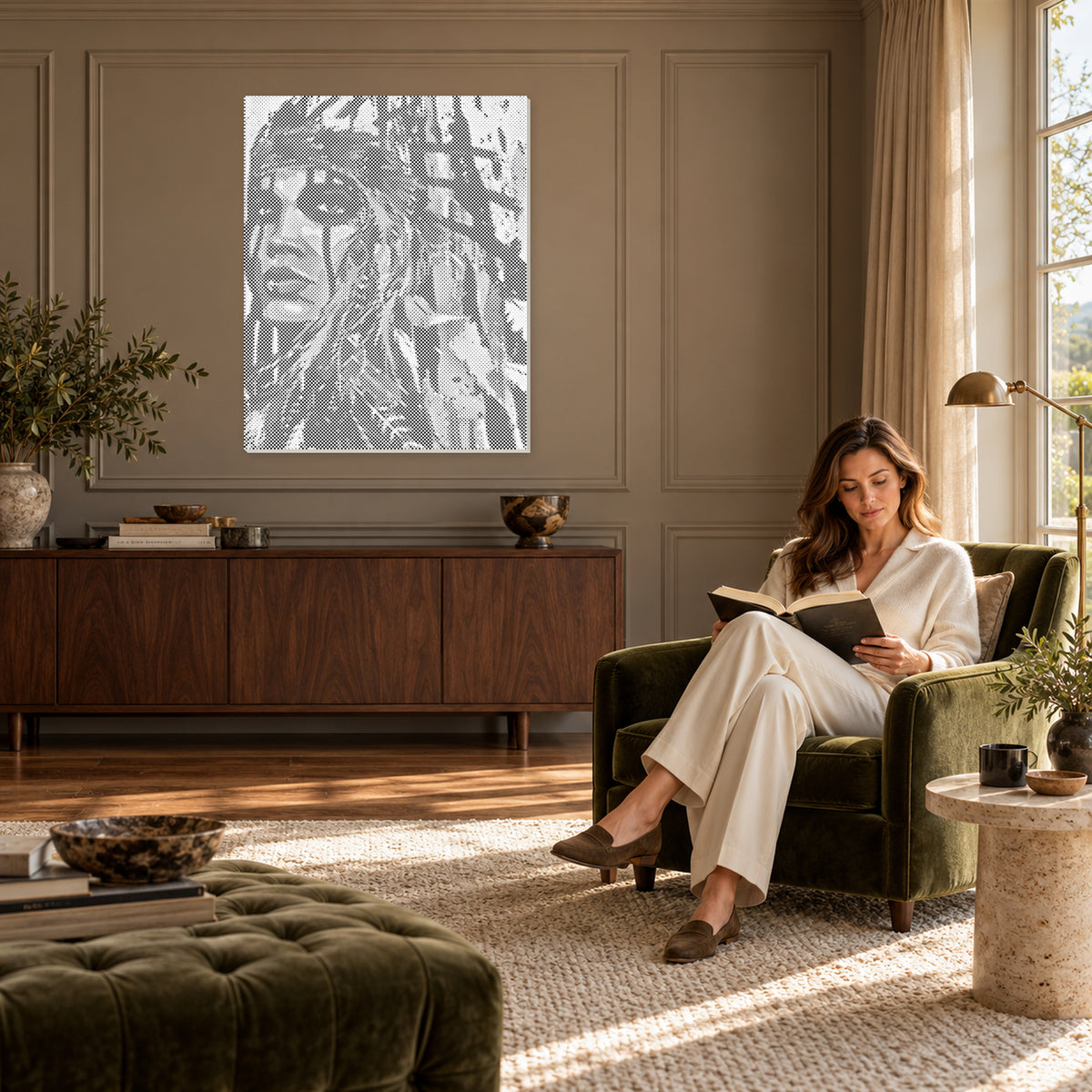Desert Reverie woman portrait with a feathered headdress dot painting in a taupe panelled reading room with a woman seated nearby.