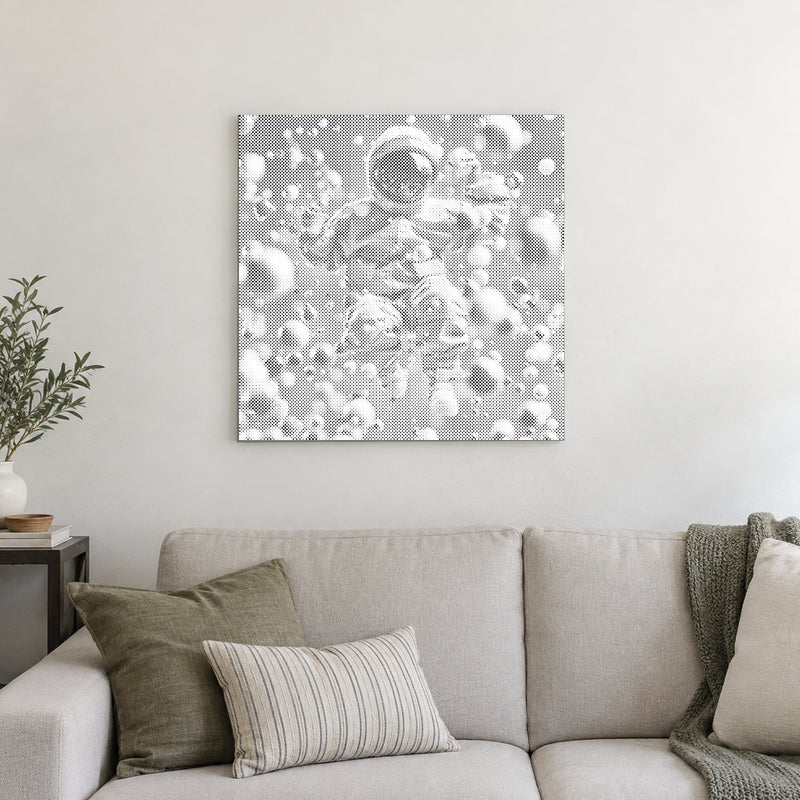 Dot-painting canvas “Abstract Astronaut”, displayed on a light wall in a softly lit room.
