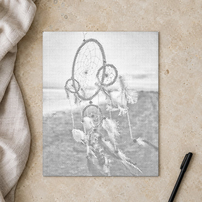 Dot-painting canvas “Dreamcatcher in the Wind”, seen from above on a worktable in soft daylight.