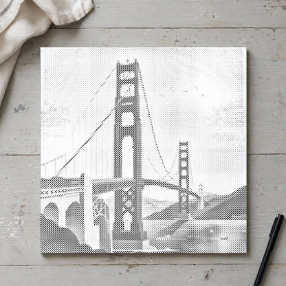 Dot-painting canvas “Golden Gate Bridge”, seen from above on a worktable in soft daylight.