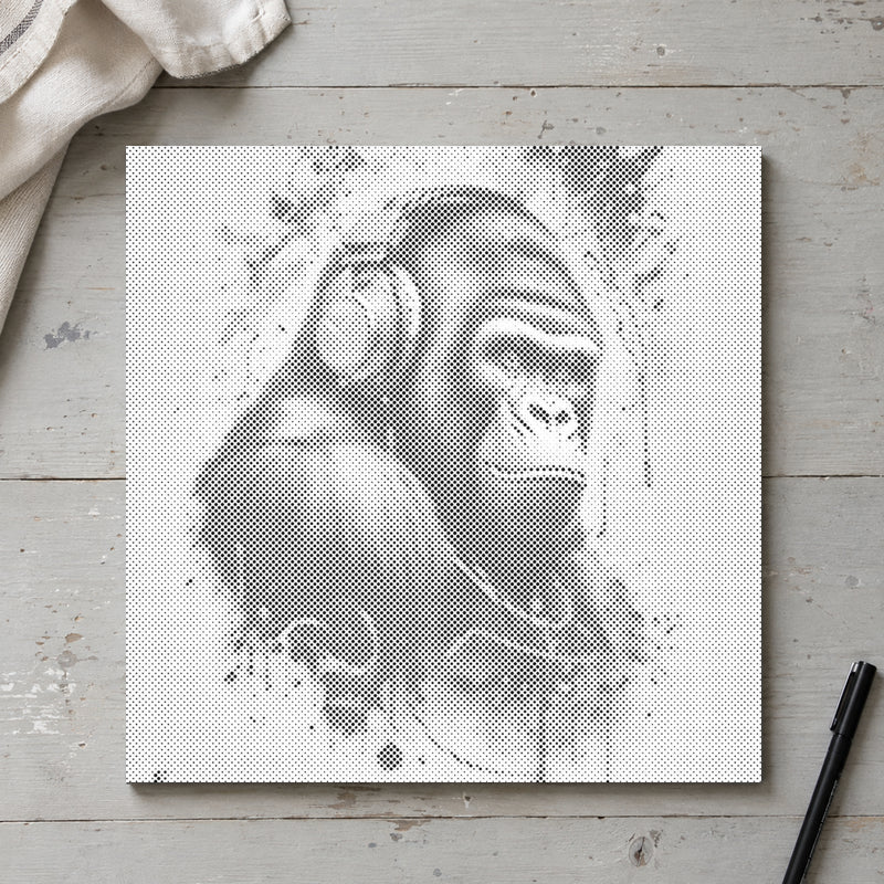Dot-painting canvas “Gorilla with Headphones”, seen from above on a worktable in soft daylight.