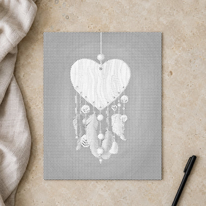 Dot-painting canvas “Heart Shaped Dreamcatcher”, seen from above on a worktable in soft daylight.